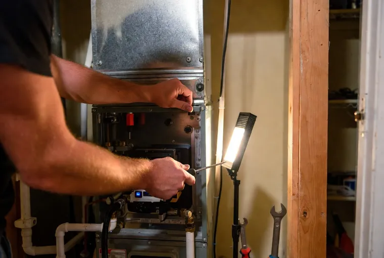 Technician servicing a furnace